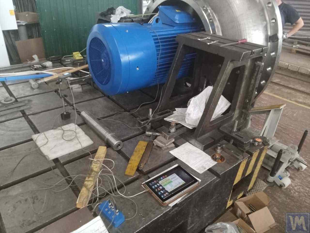 Équilibrage d'un ventilateur industriel : capteurs de vibration installés, tachymètre laser, tablette exécutant le logiciel de diagnostic